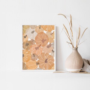 This autumn seasonal printable features scattered pumpkins painted in earthy orange, brown and yellow colors. Perfect printable art for any home this fall season!