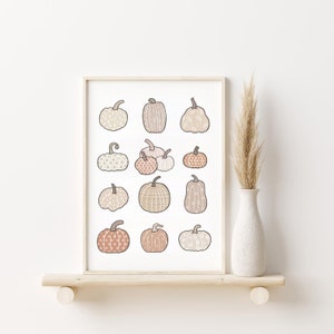 This boho autumn seasonal printable features scattered pumpkins painted in pastel earthy orange, brown and beige colors. Perfect printable art for any home this fall season!