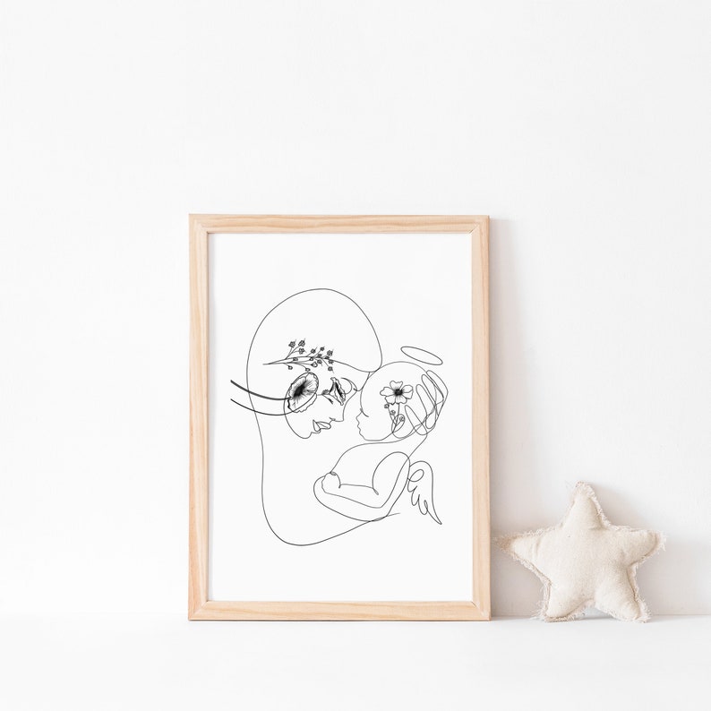 May include: A black and white line drawing of a mother holding a baby. The baby has a halo above its head and both the mother and baby have flowers in their hair.