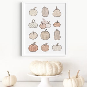 This boho autumn seasonal printable features scattered pumpkins painted in pastel earthy orange, brown and beige colors. Perfect printable art for any home this fall season!