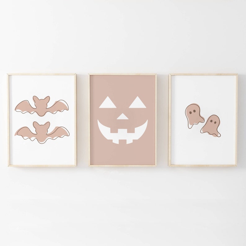 Three Halloween prints. The first print features two blush colored bats, the second print is a blush colored jack’o-lantern and the third print is two adorable blush colored ghosts.