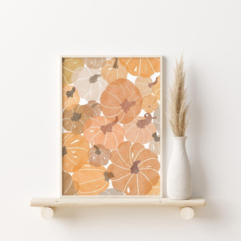 This autumn seasonal printable features scattered pumpkins painted in earthy orange, brown and yellow colors. Perfect printable art for any home this fall season!