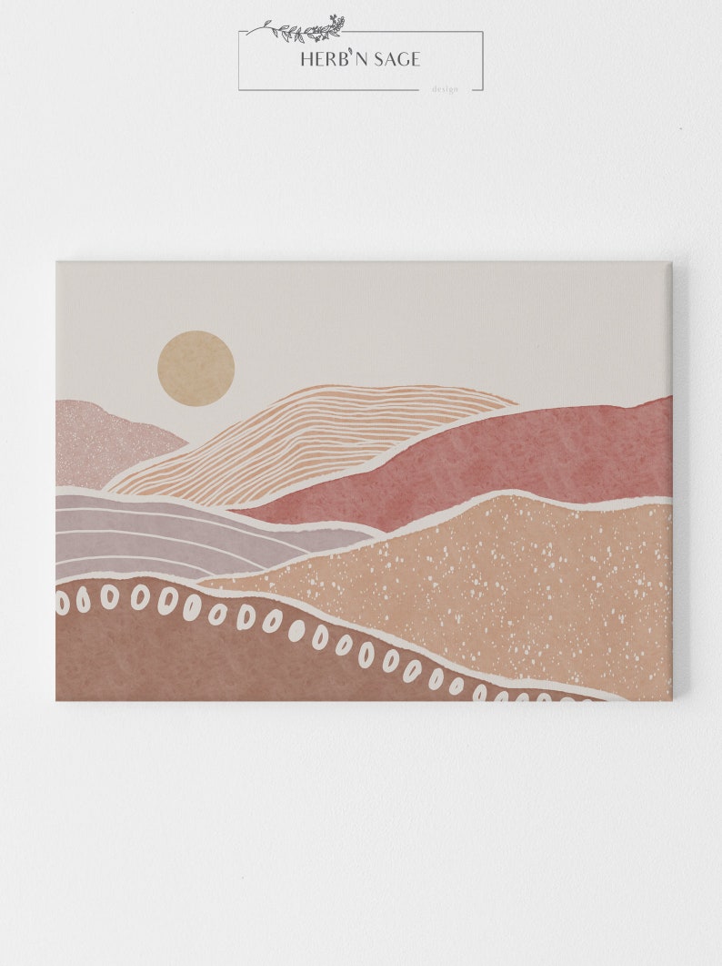 Peut inclure: Impression d'art abstrait repr&eacute;sentant un paysage stylis&eacute; avec des collines superpos&eacute;es dans des tons de rose, brun et beige. L'impression comprend un soleil dans le coin sup&eacute;rieur gauche et une bordure blanche.