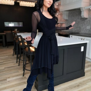 Short flowy dress. This navy dress is classic and fun with a double layer circle skirt and unsymmetrical hemline. Jackets sold separately.