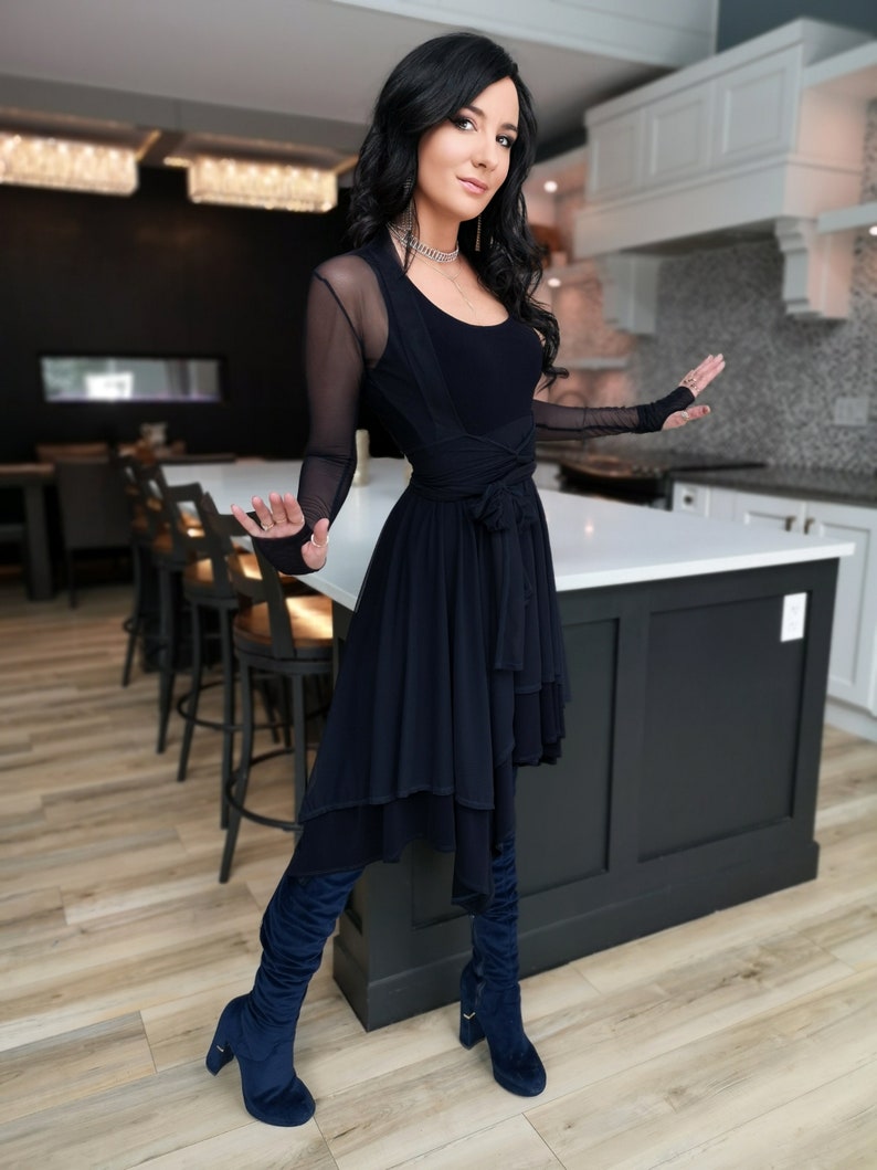 Short flowy dress. This navy dress is classic and fun with a double layer circle skirt and unsymmetrical hemline. Jackets sold separately.