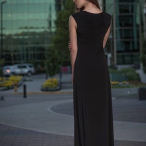 Black long maxi dress with cap sleeves, round neck and fitted through the waist this dress falls beautifully to the floor.