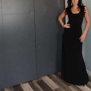 Black long maxi dress with cap sleeves, round neck and fitted through the waist this dress falls beautifully to the floor.