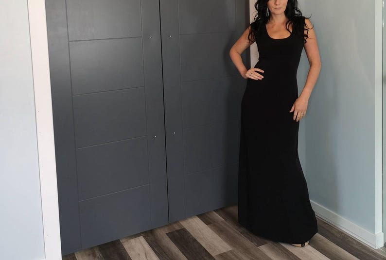 Black long maxi dress with cap sleeves, round neck and fitted through the waist this dress falls beautifully to the floor.