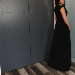 Black long maxi dress with cap sleeves, round neck and fitted through the waist this dress falls beautifully to the floor.