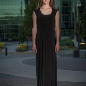 Black long maxi dress with cap sleeves, round neck and fitted through the waist this dress falls beautifully to the floor.