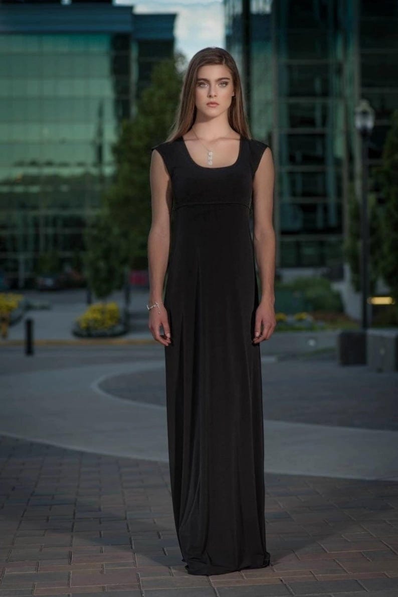 Black long maxi dress with cap sleeves, round neck and fitted through the waist this dress falls beautifully to the floor.