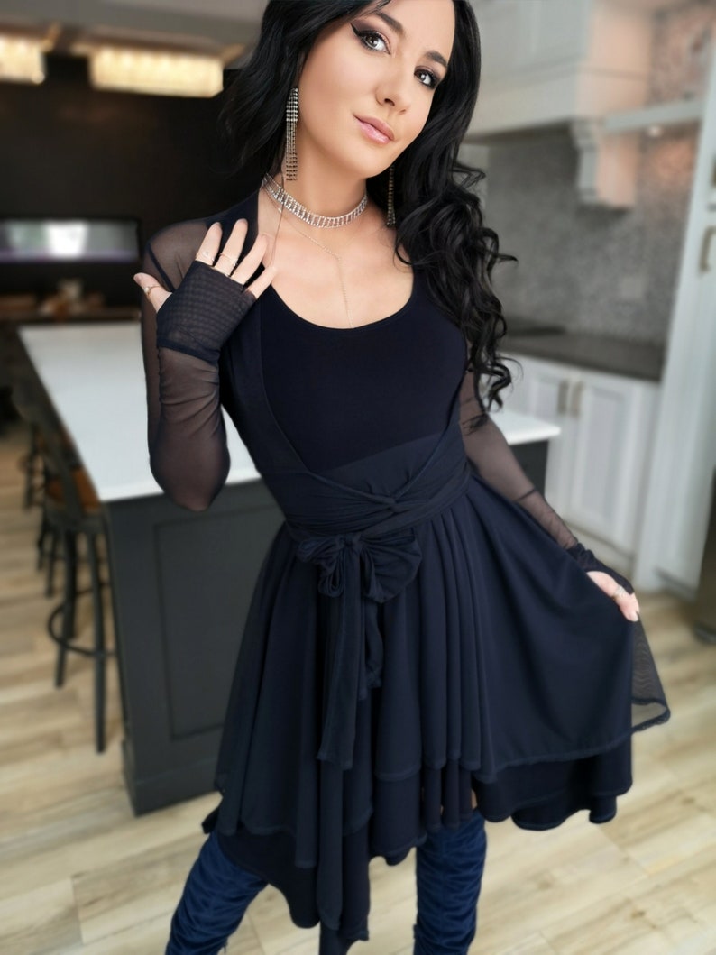 Short flowy dress. This navy dress is classic and fun with a double layer circle skirt and unsymmetrical hemline. Jackets sold separately.