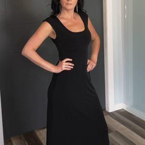 Black long maxi dress with cap sleeves, round neck and fitted through the waist this dress falls beautifully to the floor.