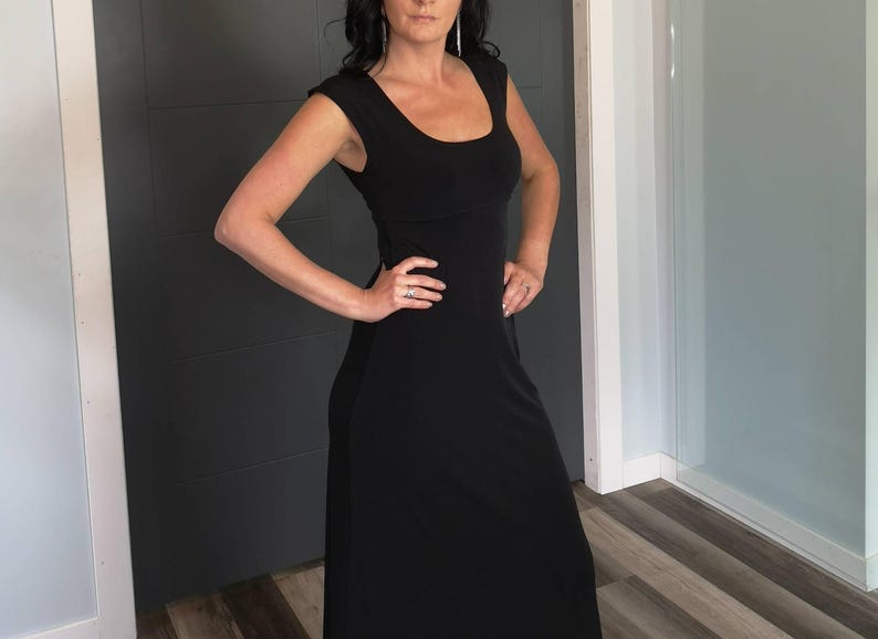 Black long maxi dress with cap sleeves, round neck and fitted through the waist this dress falls beautifully to the floor.