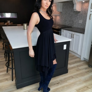 Short flowy dress. This navy dress is classic and fun with a double layer circle skirt and unsymmetrical hemline. Jackets sold separately.