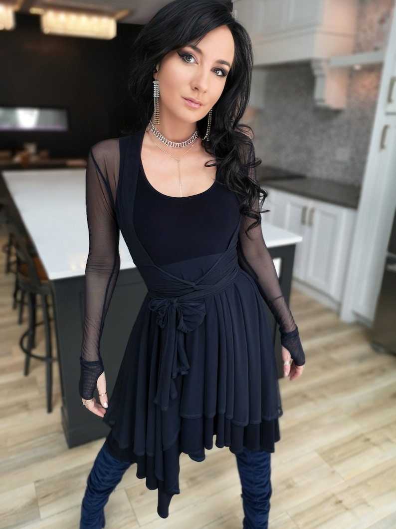Short flowy dress. This navy dress is classic and fun with a double layer circle skirt and unsymmetrical hemline. Jackets sold separately.