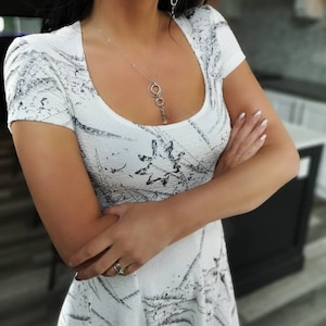 Short dress. Short white tissue hem dress. The dress has a round neck with a cap sleeve and empire waist.