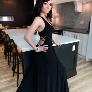 Black backless maxi dress. This dress features an exposed back with a beautiful string details. Classy, sexy and fun.