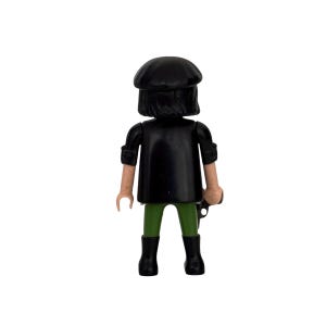 May include: A black plastic toy figure wearing a black beret, a black jacket, green pants, and black boots.