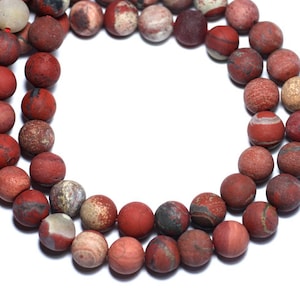 Peut inclure: Un collier de perles de jaspe rouge, brun et blanc. Les perles sont rondes et ont une finition lisse et polie.