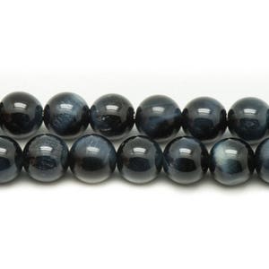 May include: A strand of dark blue round beads with a subtle shimmer. The beads are made of tiger's eye stone.