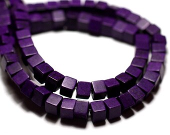 May include: A strand of purple square beads. The beads are made of a smooth, polished material and have a slightly iridescent finish.