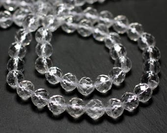 May include: A strand of clear faceted crystal beads. The beads are round and have a smooth, polished finish.