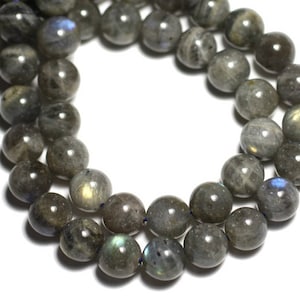 May include: A strand of dark gray labradorite gemstone beads. The beads are round and have a slight iridescent sheen.