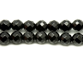 May include: Two strands of faceted, black onyx beads. The beads are round with multiple facets, creating a sparkling effect. The beads are strung together, ready for jewelry making or other crafts.