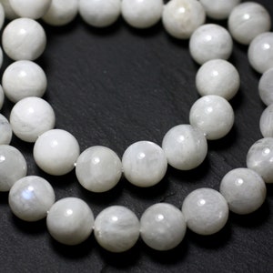 May include: A strand of white moonstone beads. The beads are round and smooth, and they have a subtle iridescent sheen.