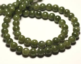 May include: A strand of olive green gemstone beads. The beads are round and have a polished, slightly translucent appearance. The beads are strung together, forming a necklace or bracelet.