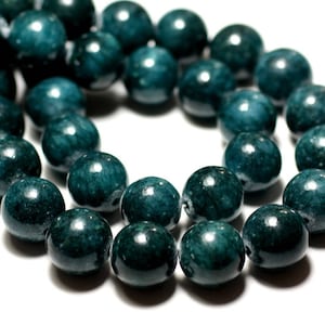 May include: A strand of dark teal green round beads. The beads are smooth and glossy.