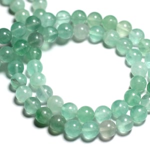 May include: A strand of light green gemstone beads. The beads are round and have a smooth, polished finish.