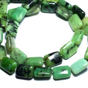 May include: A strand of green gemstone beads, each bead is rectangular and has a mottled green and black pattern.
