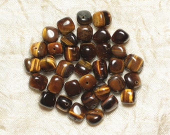 May include: A collection of approximately 30 brown and gold tiger's eye gemstone beads. The beads are tumbled and have a smooth, polished finish. They are all roughly the same size and shape, with a slightly rectangular form.