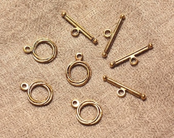 May include: Seven gold-toned metal clasps for jewelry making.  Four clasps are round with a double ring design. Three clasps are straight with a bar and two loops.
