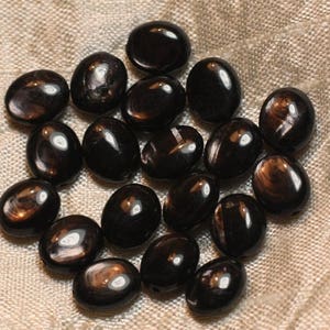 May include: A collection of oval-shaped black gemstone beads with a shimmering, iridescent finish.
