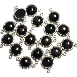 May include: A group of 17 black gemstone beads with silver accents. Each bead has two loops for attaching to a chain or other jewellery.