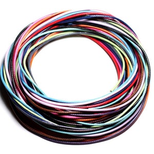 May include: A collection of colorful waxed cords, arranged in a circle, showcasing a variety of shades and textures.
