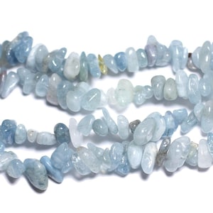 May include: A strand of light blue aquamarine chip beads. The beads are irregular in shape and have a natural, tumbled finish.