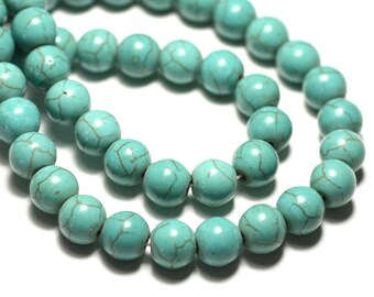 May include: A strand of turquoise beads, each bead is round and has a light blue color with brown veining.