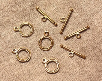 May include: A set of six gold-toned metal toggle clasps for jewellery making. The clasps are in two styles: a round, double-ring design and a straight bar with a loop at each end.