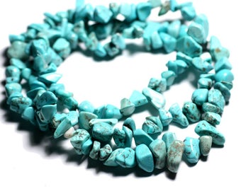 May include: A strand of turquoise gemstone beads, featuring a mix of irregular shapes and sizes. The beads are a vibrant blue-green color and have a natural, earthy look.