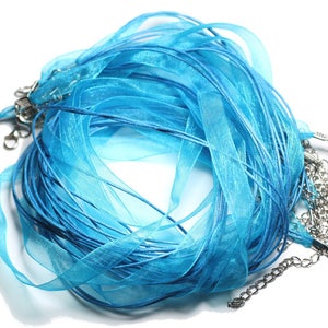 May include: A bundle of light blue satin ribbon with silver clasps. The ribbon is ideal for crafting, jewellery making, and gift wrapping.