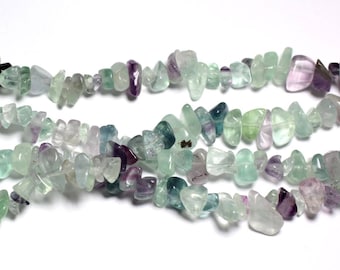 May include: A strand of green, purple, and blue fluorite chip beads. The beads are irregular in shape and have a natural, tumbled finish.