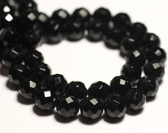 May include: A strand of black faceted gemstone beads. The beads are round and have a shiny finish.