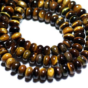 Puede incluir: Una hebra de cuentas de ojo de tigre, de color marrón dorado y efecto brillante. Las cuentas son redondas y tienen un acabado liso y pulido.