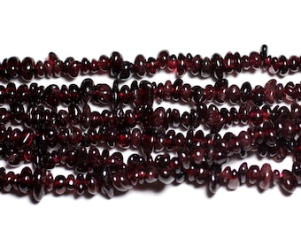 May include: A strand of dark red garnet gemstone beads. The beads are small and irregular in shape, with a smooth, polished finish.
