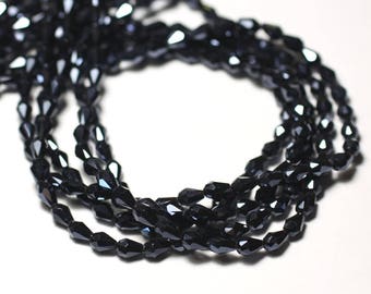 May include: A strand of black faceted glass beads. The beads are strung together to form a necklace or bracelet.