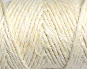 May include: Close-up of a thick, natural cream-colored rope made of tightly woven fibers.